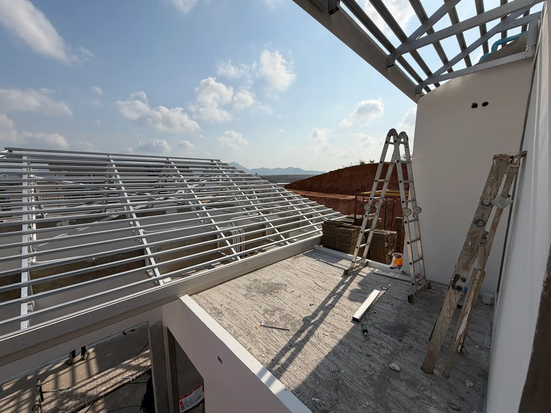 A framed rooftop terrace with coast and mountain views at KĀHLĪ Phuket