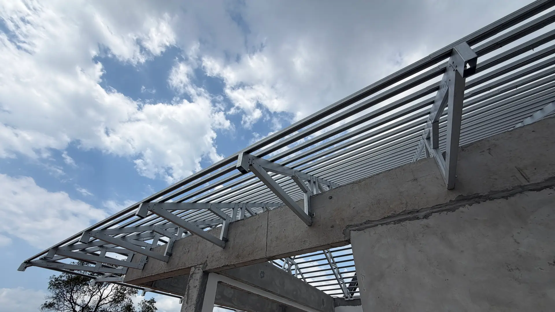 Steel roof framing engineered over a precast villa shell at KĀHLĪ Phuket